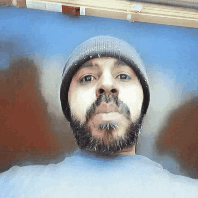 a man with a beard wearing a beanie