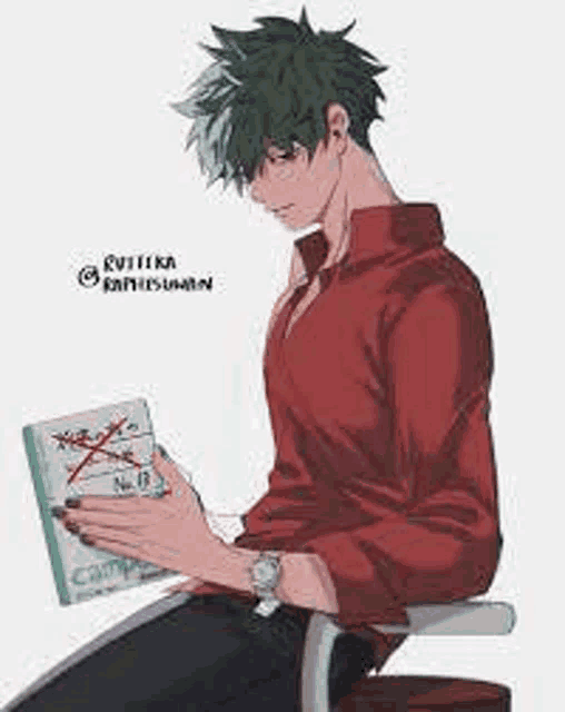 a young man is sitting in a chair reading a book .