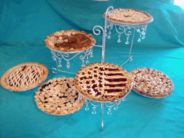 a bunch of pies are sitting on a metal stand