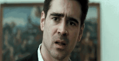 a man in a suit and white shirt is making a funny face .