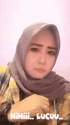 a woman wearing a hijab and a plaid shirt with the words hiihii lucuu
