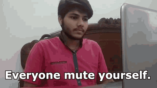 a man sitting in front of a laptop with the words everyone mute yourself written below him