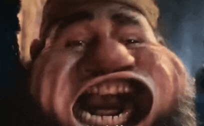 a close up of a man with a beard making a funny face with his mouth wide open .