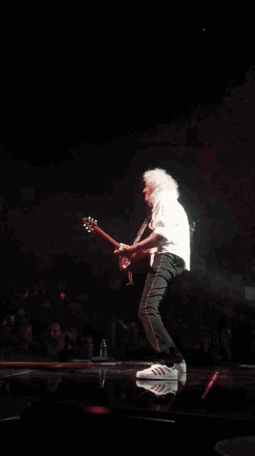 a man is singing into a microphone on a stage