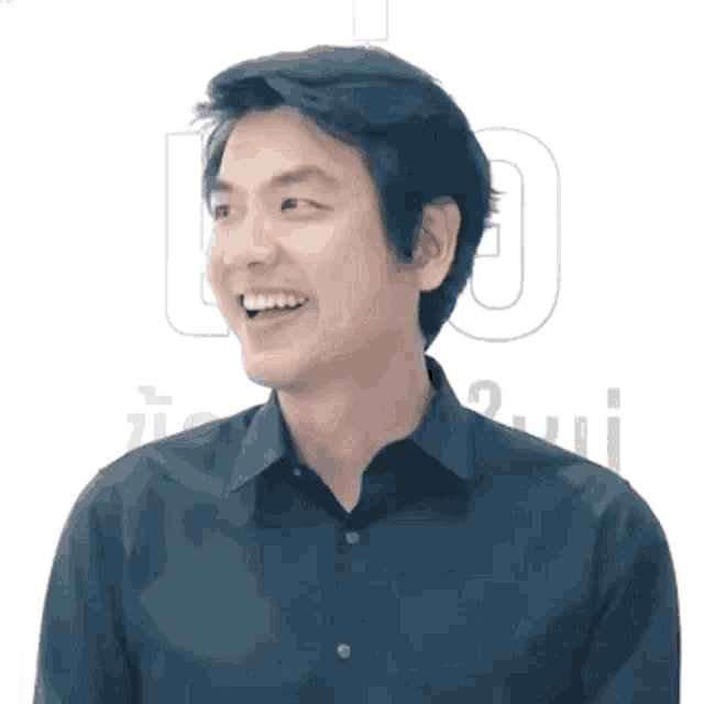 a man in a black shirt is smiling in front of a white background with the letter o in the corner