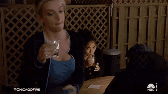 a woman is drinking from a glass with the hashtag #chicagofire