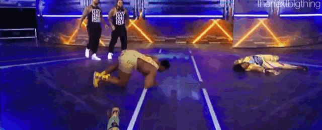 a man is crawling on the floor while a woman is laying on the ground .