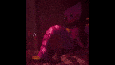 a purple monster is holding a yellow object in its hand .