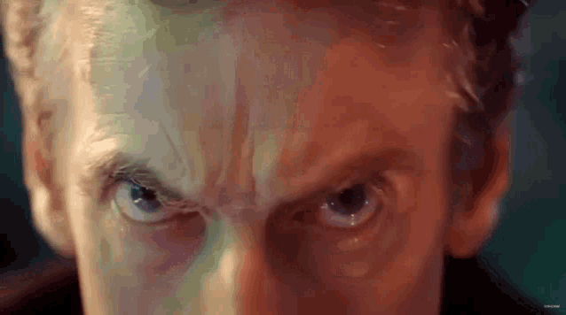 a close up of a man 's face with a very angry look on his face