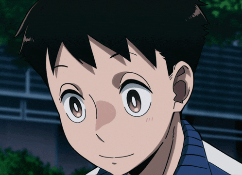 a close up of a boy 's face with a blue shirt