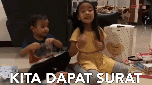 a boy and a girl are sitting on the floor with the words kita dapat surat written on the bottom
