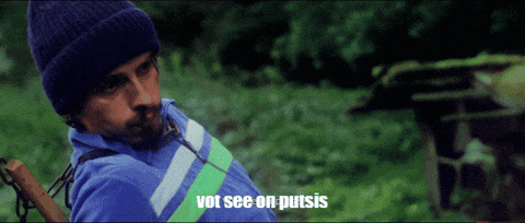 a man wearing a blue shirt and a beanie says vot see on putsis