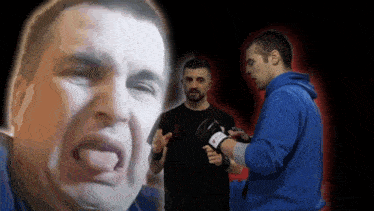 a man in a blue hoodie is standing next to another man in a black shirt