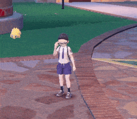 a boy in a white shirt and blue shorts is standing on a brick sidewalk