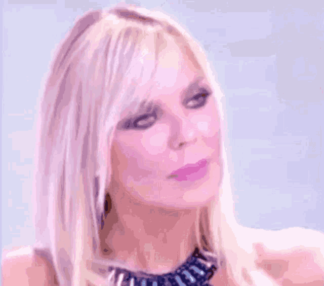 a close up of a woman 's face with blonde hair