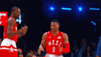 a basketball player in a red west jersey is dancing
