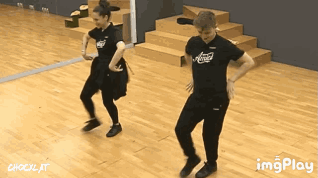 a man and a woman are dancing in a dance studio with a shocklat watermark on the bottom