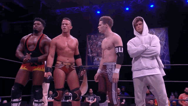 a group of wrestlers are standing in a ring and one of them has a sleeve that says bli on it