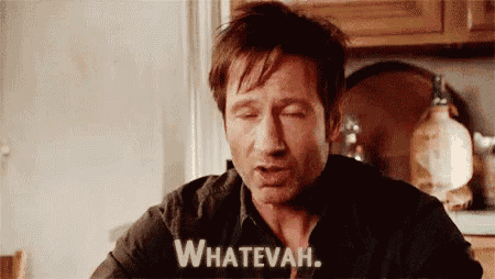 a man is sitting at a table in a kitchen with his eyes closed and says whatevah .