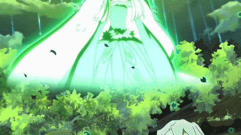 a woman in a white dress is surrounded by green leaves