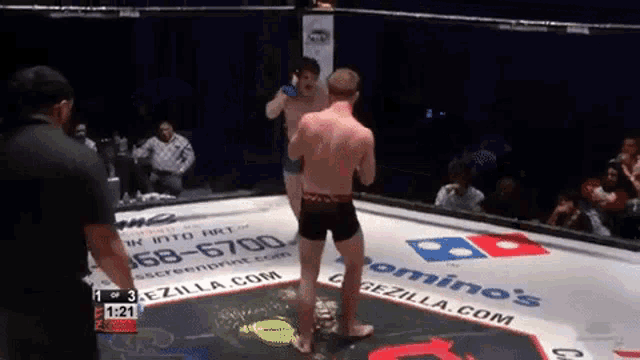 a boxing ring with a domino 's sign on the floor