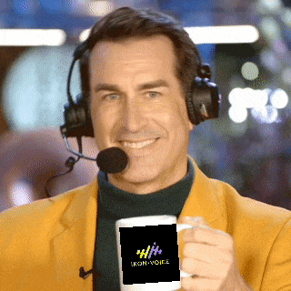 a man wearing headphones holds a mug that says iron voice