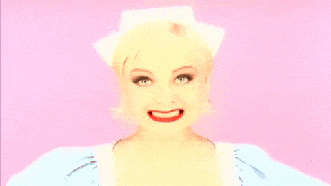 a close up of a woman 's face with a surprised expression