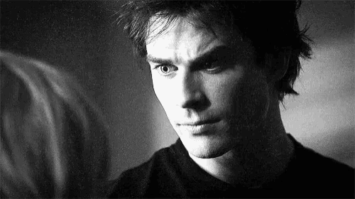 a close up of a man 's face with a serious look on his face in a black and white photo .