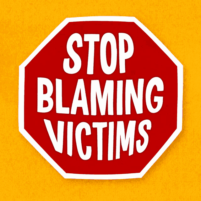 a red stop sign that says stop blaming victims