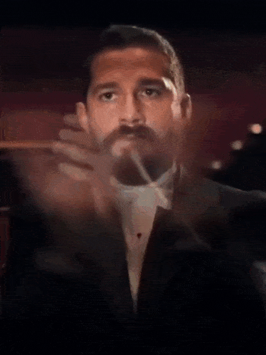 a man in a tuxedo and bow tie with the words join us now below him