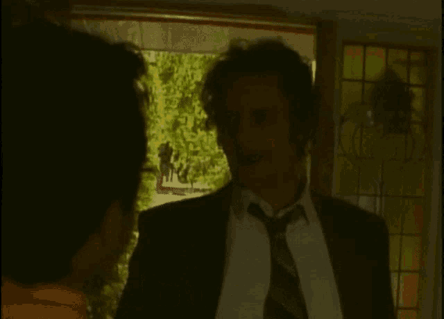 a man in a suit and tie is talking to another man with the words " 6,000 kavanaghs and " behind him