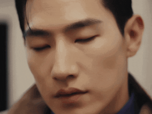 a close up of a man with his eyes closed