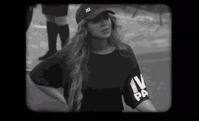 a black and white photo of a woman wearing a shirt that says iv pa on the sleeve
