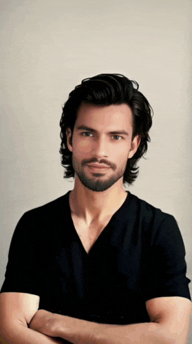 a man with a beard is wearing a black shirt