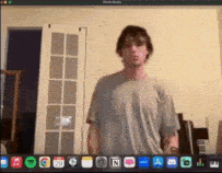 a man is standing in front of a computer screen that says photo booth on it