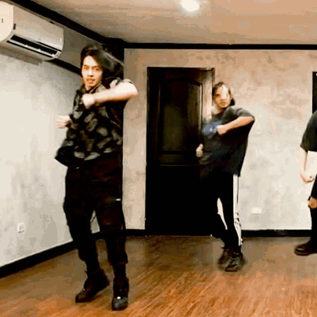 a group of people are dancing in a room with a door