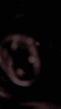 a blurred image of a person 's face with a few spots of light on it