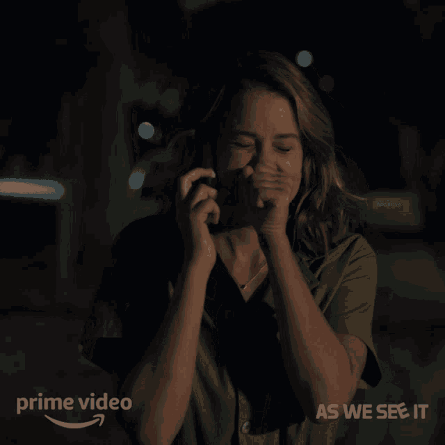 a woman covering her mouth while talking on a phone with the words " as we see it " on the bottom