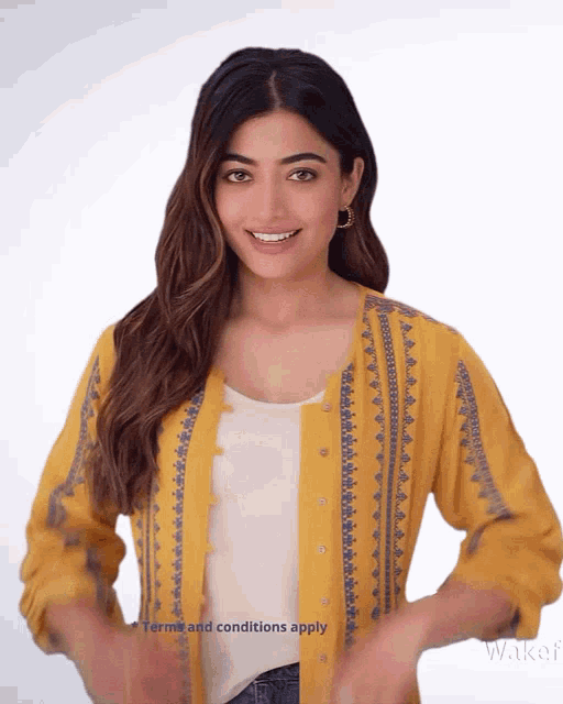 a woman wearing a yellow jacket with the words terms and conditions apply
