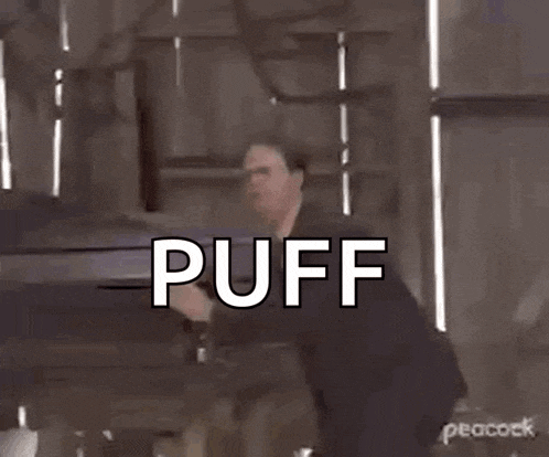 a man in a suit and tie is standing in front of a coffin and saying `` puff just get in the coffin '' .
