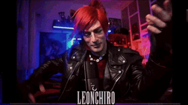 a man with red hair is sitting in front of a microphone and the name leonhiro is on the bottom