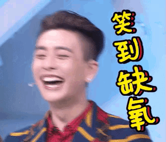 a man in a striped jacket is laughing with chinese writing behind him