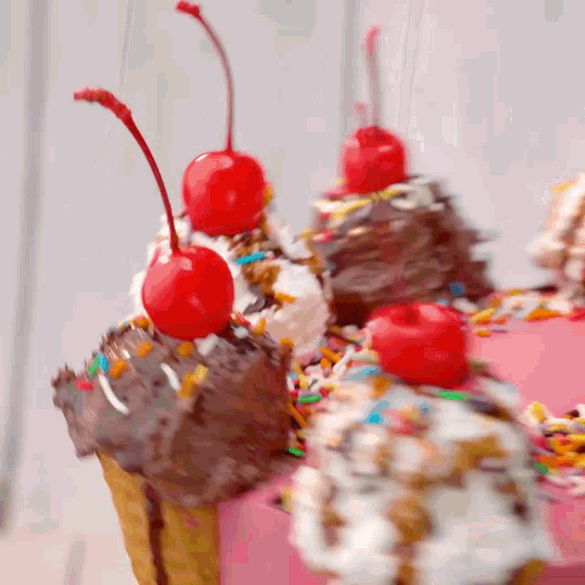 a close up of a cupcake with a cherry on top of it
