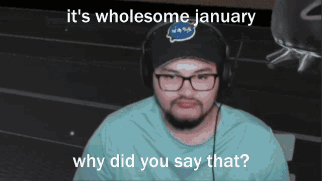 a man wearing a nasa hat and headphones says it 's wholesome january