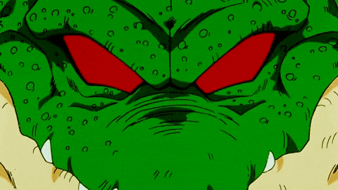 a close up of a green cartoon character with red eyes