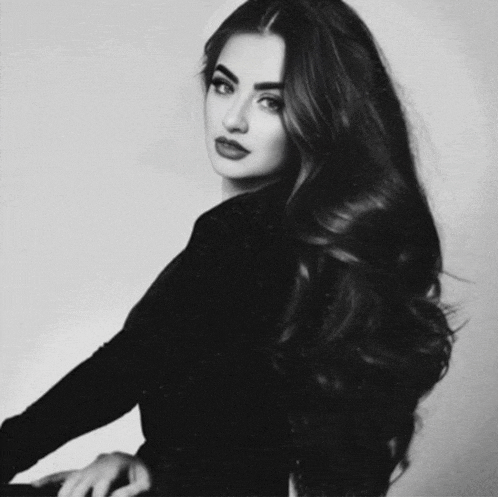 a black and white photo of a woman with very long dark hair