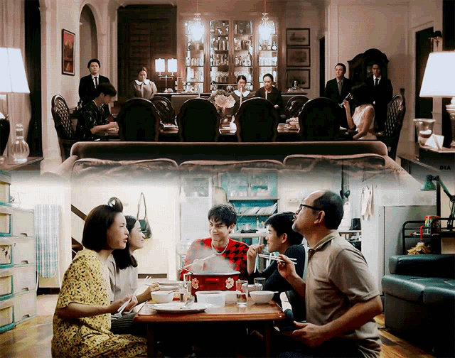 a group of people are sitting at a table with plates of food and a man is eating with chopsticks