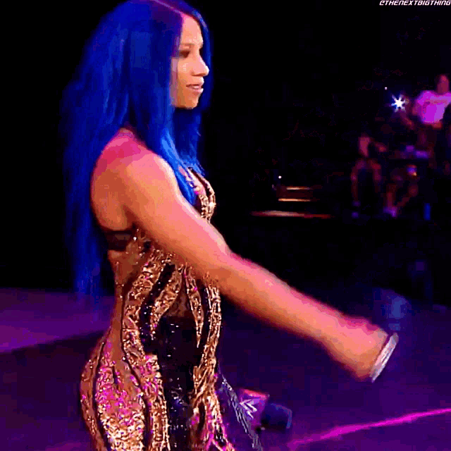 a woman with blue hair is wearing a black and gold dress