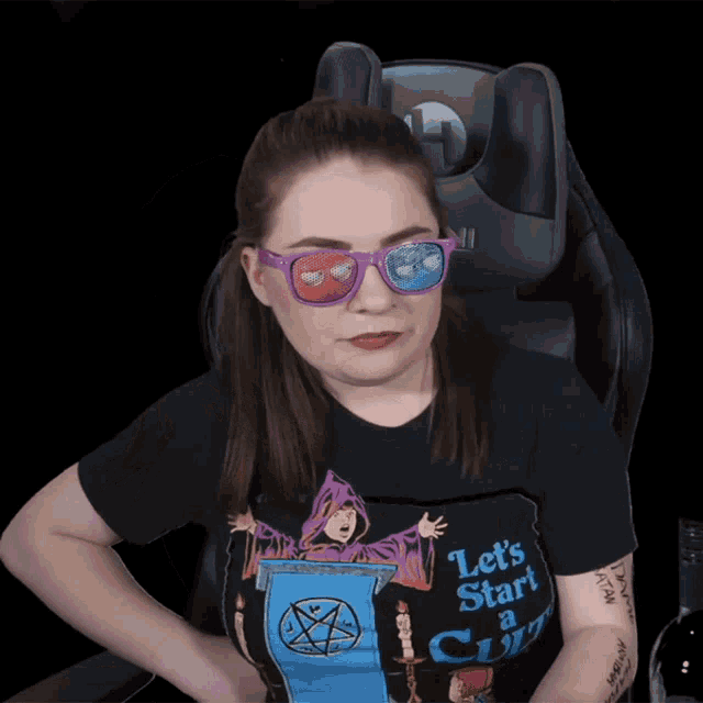 a woman wearing sunglasses and a black shirt that says let 's start a cult