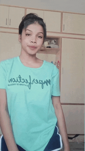 a girl wearing a t-shirt that says ' freedom no more ' on it